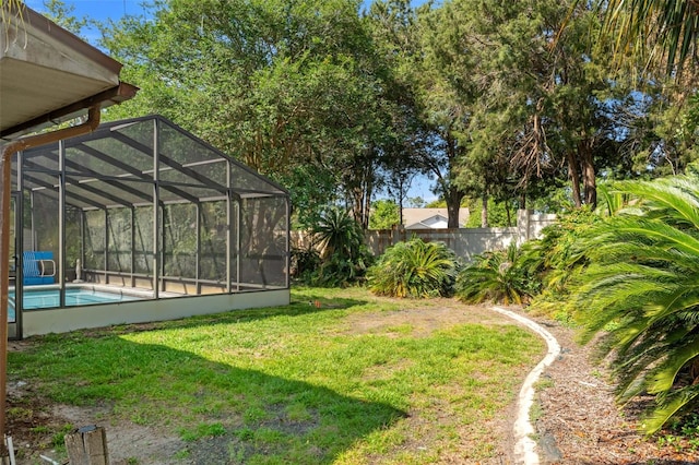 3029 Harrow Rd, Spring Hill, FL 34606 - view of yard featuring glass enclosure, fence, and a fenced in pool