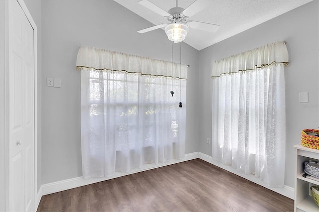 14105 Agua Clara Dr, Hudson, FL 34667 - unfurnished dining area featuring lofted ceiling, a ceiling fan, and wood finished floors