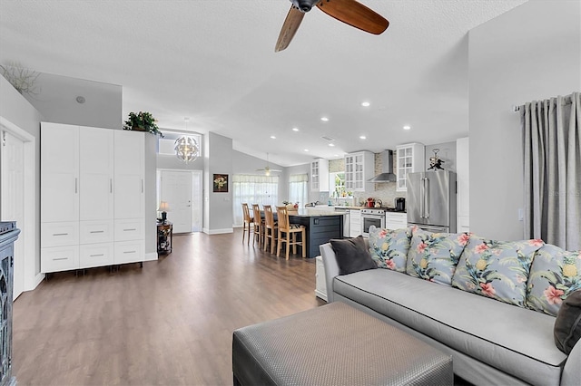 14105 Agua Clara Dr, Hudson, FL 34667 - living room with ceiling fan, vaulted ceiling, dark wood-style flooring, and recessed lighting