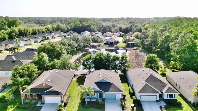 birds eye view of property featuring a residential view and a forest view
