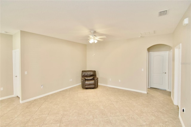 unfurnished room featuring baseboards, visible vents, ceiling fan, and light tile patterned flooring