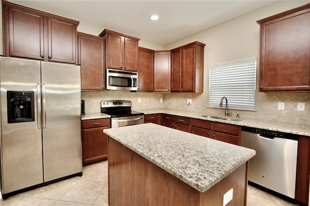 kitchen with light tile patterned flooring, backsplash, stainless steel appliances, and a sink