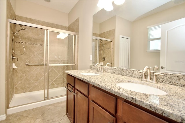 full bathroom featuring a shower stall, tile patterned floors, and a sink