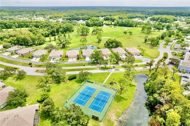 drone / aerial view featuring view of golf course and a water view