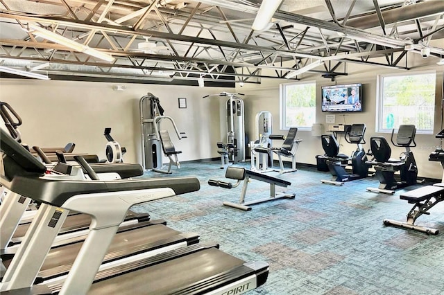 gym featuring baseboards and carpet flooring
