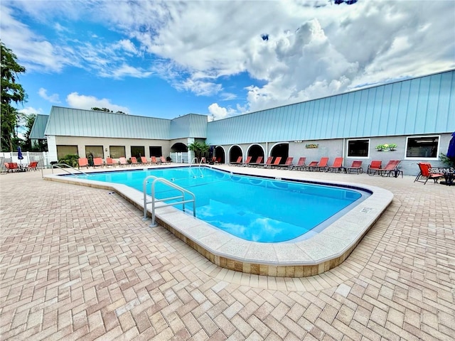 pool featuring fence and a patio area