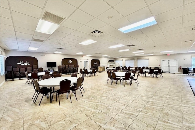 dining space featuring visible vents and a drop ceiling