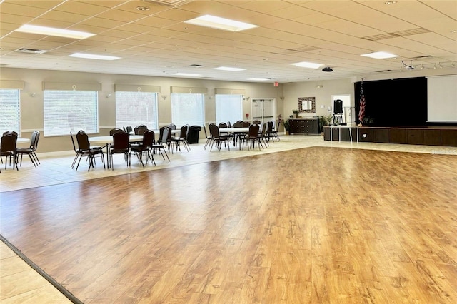 miscellaneous room featuring a paneled ceiling, visible vents, and light wood-style floors