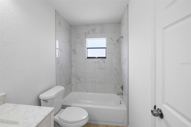 full bath with a textured wall, vanity, and washtub / shower combination