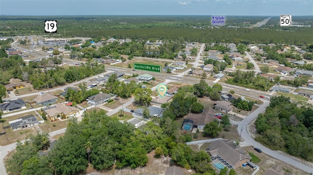 birds eye view of property featuring a residential view and a wooded view