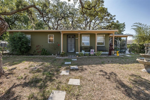 view of front of home featuring a sunroom and stucco siding
