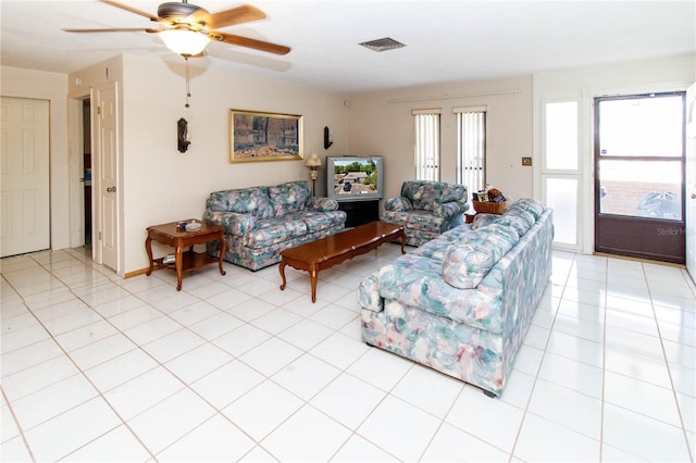 living room with visible vents, ceiling fan, and light tile patterned floors