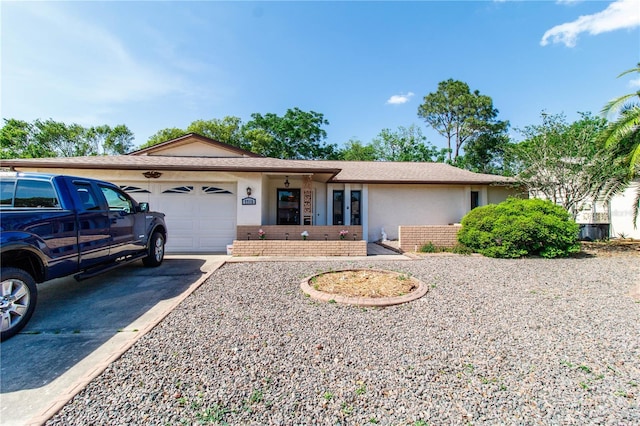 ranch-style home with brick siding, an attached garage, driveway, and a shingled roof