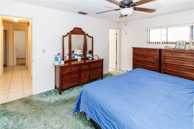 bedroom with carpet flooring, ceiling fan, and visible vents