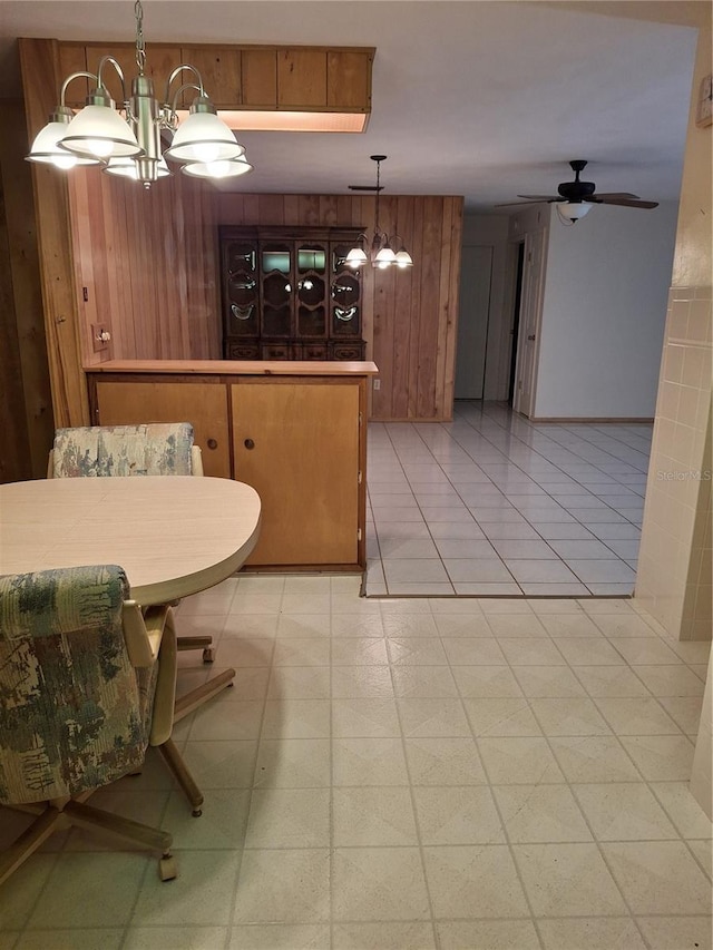 7715 Gulf Highlands Dr, Port Richey, FL 34668 - dining space with wooden walls, ceiling fan, and a chandelier