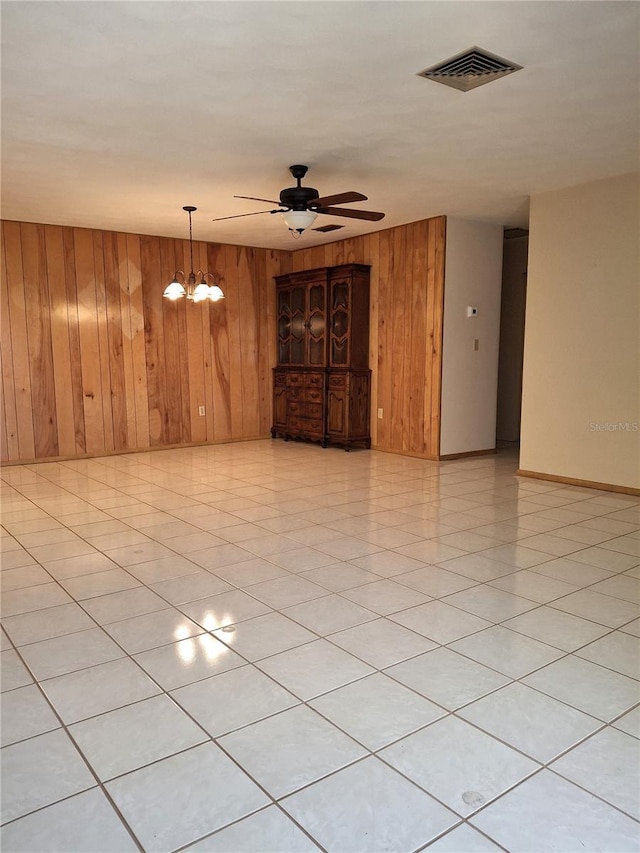 7715 Gulf Highlands Dr, Port Richey, FL 34668 - unfurnished room with wooden walls, ceiling fan, baseboards, and a chandelier