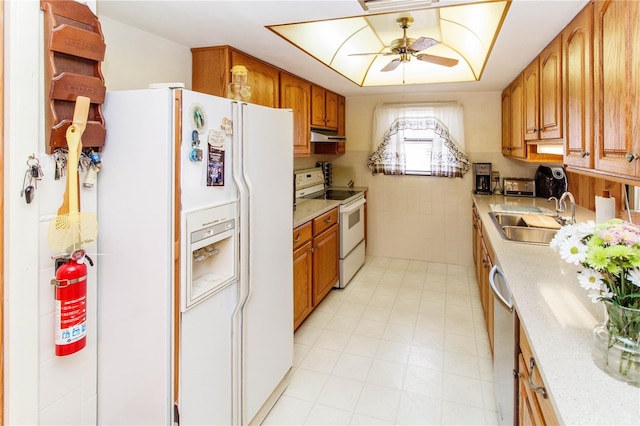 7715 Gulf Highlands Dr, Port Richey, FL 34668 - kitchen featuring white appliances, a sink, ceiling fan, light countertops, and brown cabinetry
