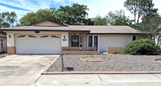 7715 Gulf Highlands Dr, Port Richey, FL 34668 - single story home featuring concrete driveway, brick siding, an attached garage, and stucco siding