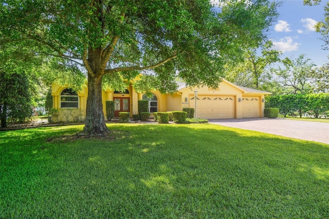 18502 Winding Oaks Blvd, Hudson, FL 34667 - view of property hidden behind natural elements with a garage, driveway, a front yard, and stucco siding