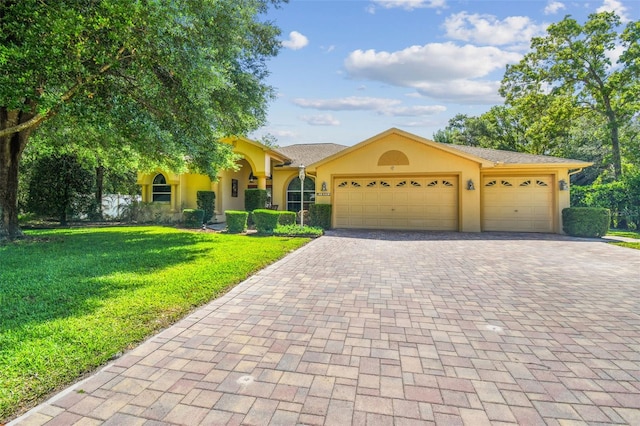 18502 Winding Oaks Blvd, Hudson, FL 34667 - view of front facade with a garage, stucco siding, decorative driveway, and a front yard