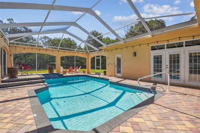 18502 Winding Oaks Blvd, Hudson, FL 34667 - outdoor pool featuring a patio, a lanai, and french doors