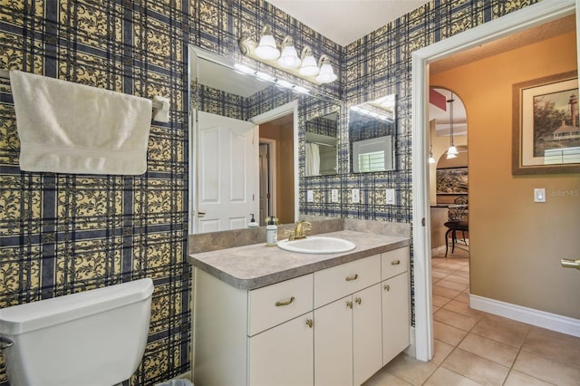 18502 Winding Oaks Blvd, Hudson, FL 34667 - bathroom with toilet, wallpapered walls, baseboards, and tile patterned flooring