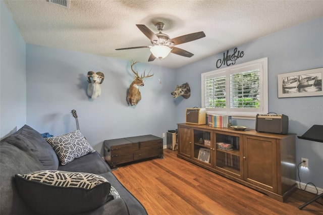 18502 Winding Oaks Blvd, Hudson, FL 34667 - interior space with a textured ceiling, ceiling fan, baseboards, and wood finished floors