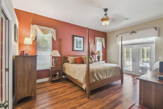 18502 Winding Oaks Blvd, Hudson, FL 34667 - bedroom featuring french doors, visible vents, baseboards, dark wood-style floors, and access to outside