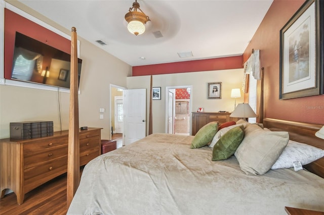 18502 Winding Oaks Blvd, Hudson, FL 34667 - bedroom featuring ceiling fan, connected bathroom, wood finished floors, and visible vents