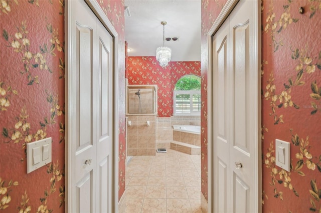 18502 Winding Oaks Blvd, Hudson, FL 34667 - full bathroom with tile patterned floors, a closet, wallpapered walls, a bath, and a stall shower