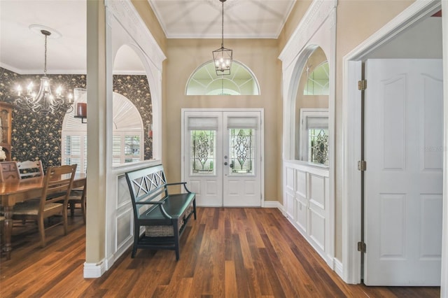 18502 Winding Oaks Blvd, Hudson, FL 34667 - foyer with crown molding, dark wood-type flooring, and a chandelier