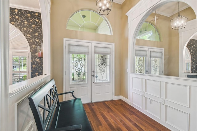 18502 Winding Oaks Blvd, Hudson, FL 34667 - entrance foyer featuring an inviting chandelier, baseboards, dark wood-style floors, wallpapered walls, and french doors