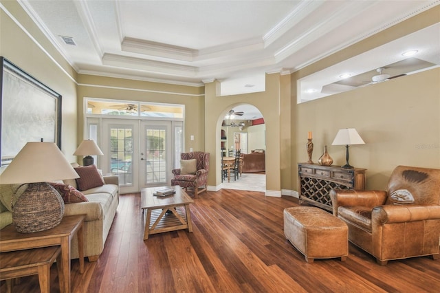 18502 Winding Oaks Blvd, Hudson, FL 34667 - living area featuring crown molding, visible vents, dark wood-type flooring, a raised ceiling, and arched walkways