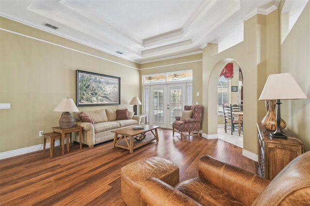18502 Winding Oaks Blvd, Hudson, FL 34667 - living room featuring french doors, visible vents, crown molding, a raised ceiling, and wood-type flooring
