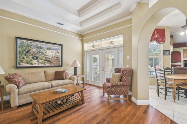 18502 Winding Oaks Blvd, Hudson, FL 34667 - living area featuring ceiling fan, french doors, visible vents, crown molding, and arched walkways