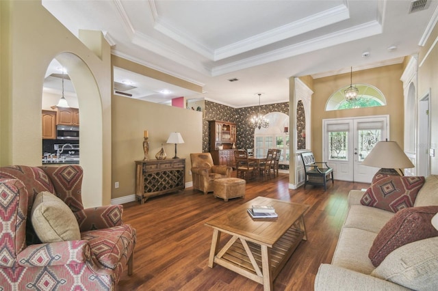 18502 Winding Oaks Blvd, Hudson, FL 34667 - living area featuring an inviting chandelier, dark wood finished floors, a tray ceiling, visible vents, and ornamental molding