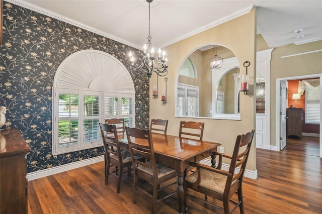 18502 Winding Oaks Blvd, Hudson, FL 34667 - dining room featuring baseboards, wallpapered walls, a notable chandelier, and wood finished floors
