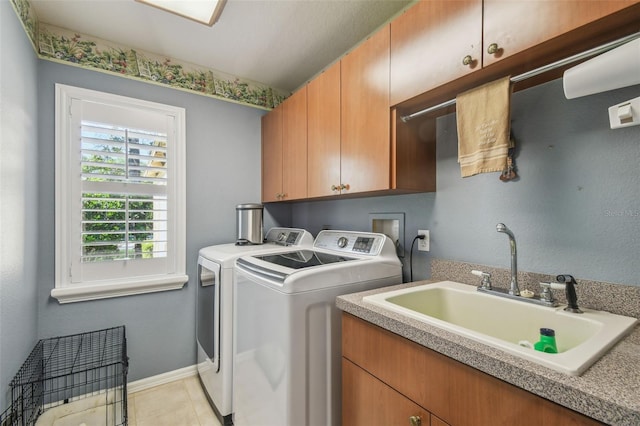 18502 Winding Oaks Blvd, Hudson, FL 34667 - laundry room featuring cabinet space, light tile patterned flooring, washing machine and clothes dryer, a sink, and baseboards