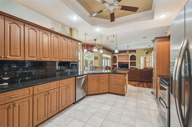 18502 Winding Oaks Blvd, Hudson, FL 34667 - kitchen with stainless steel appliances, ceiling fan, open floor plan, and a peninsula