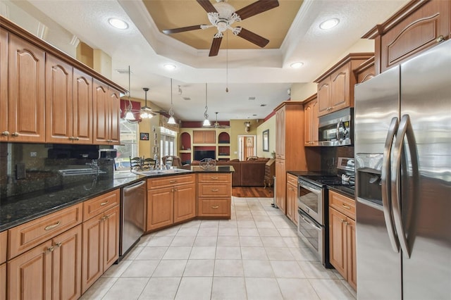 18502 Winding Oaks Blvd, Hudson, FL 34667 - kitchen featuring backsplash, stainless steel appliances, ceiling fan, and open floor plan