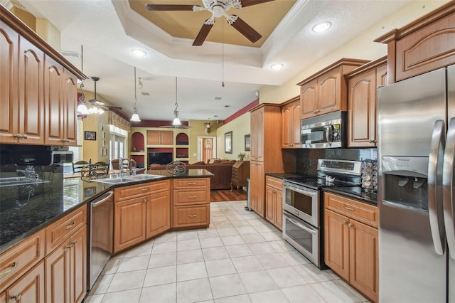 18502 Winding Oaks Blvd, Hudson, FL 34667 - kitchen featuring stainless steel appliances, a ceiling fan, open floor plan, and a sink