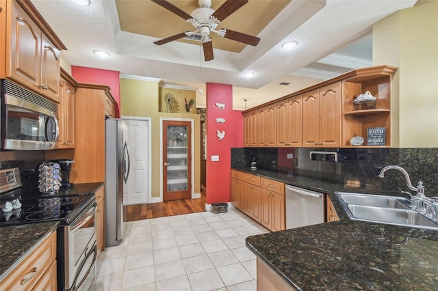 18502 Winding Oaks Blvd, Hudson, FL 34667 - kitchen with appliances with stainless steel finishes, open shelves, a sink, light tile patterned floors, and a raised ceiling