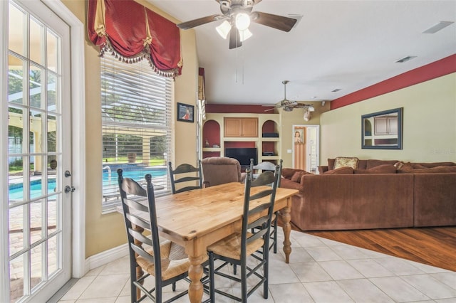 18502 Winding Oaks Blvd, Hudson, FL 34667 - dining area with light tile patterned floors, baseboards, a ceiling fan, and visible vents
