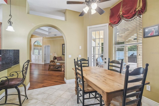 18502 Winding Oaks Blvd, Hudson, FL 34667 - dining area with baseboards, arched walkways, ceiling fan, and light tile patterned floors