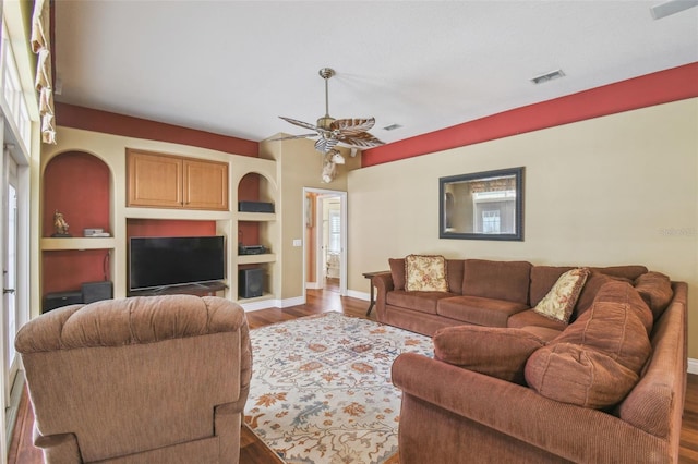 18502 Winding Oaks Blvd, Hudson, FL 34667 - living area with built in features, a ceiling fan, baseboards, wood finished floors, and visible vents