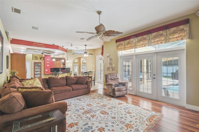 18502 Winding Oaks Blvd, Hudson, FL 34667 - living area featuring french doors, a ceiling fan, plenty of natural light, and wood finished floors