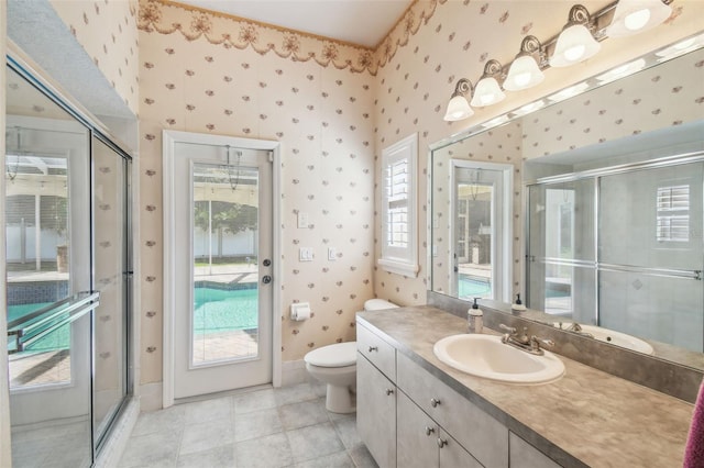18502 Winding Oaks Blvd, Hudson, FL 34667 - full bath with vanity, toilet, tile patterned floors, wallpapered walls, and a shower stall