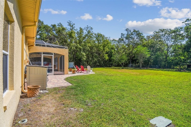 18502 Winding Oaks Blvd, Hudson, FL 34667 - view of yard with a patio and glass enclosure