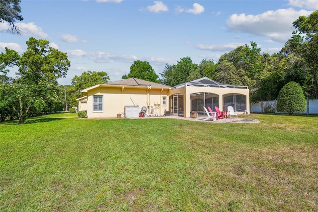 18502 Winding Oaks Blvd, Hudson, FL 34667 - rear view of property featuring fence, a patio, stucco siding, a lanai, and a yard