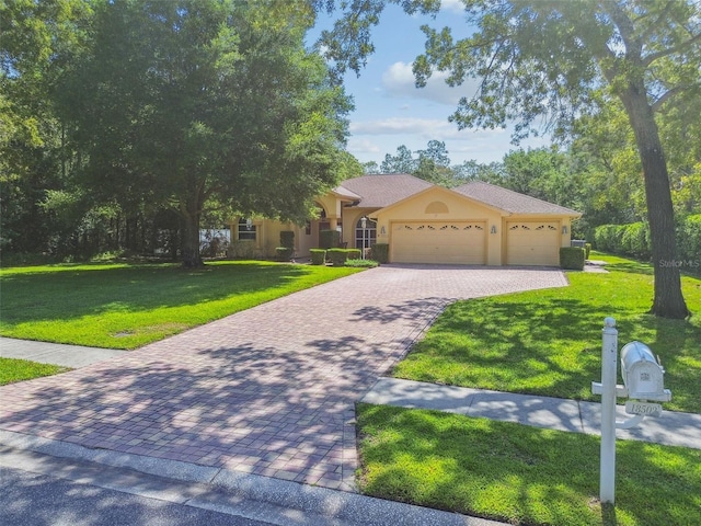 18502 Winding Oaks Blvd, Hudson, FL 34667 - view of front of property featuring stucco siding, decorative driveway, an attached garage, and a front lawn